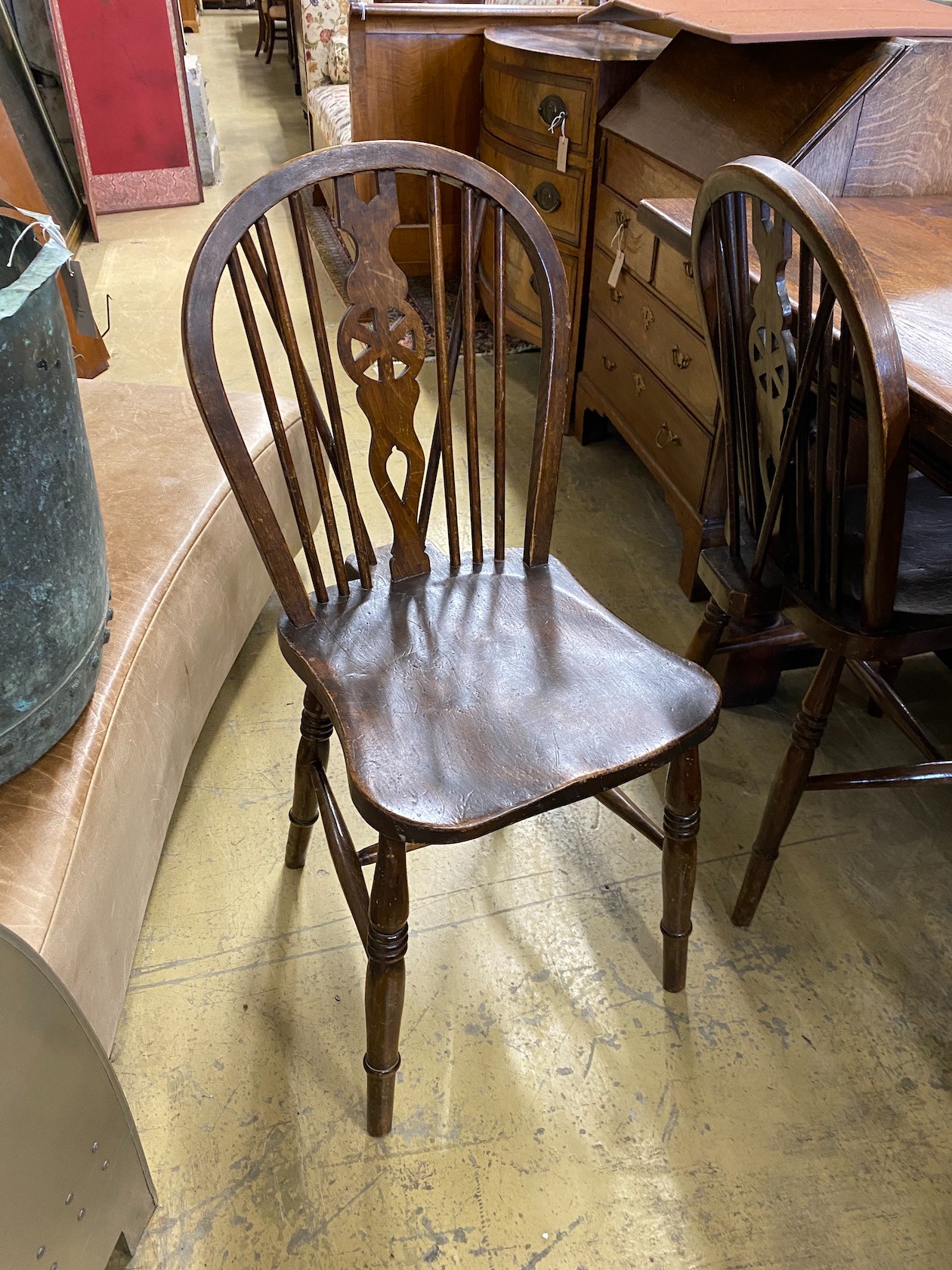 A small 18th century style rectangular oak refectory dining table, length 137cm, width 98cm, height 75cm and a harlequin set of six elm and beech Windsor wheelback dining chairs, two with arms